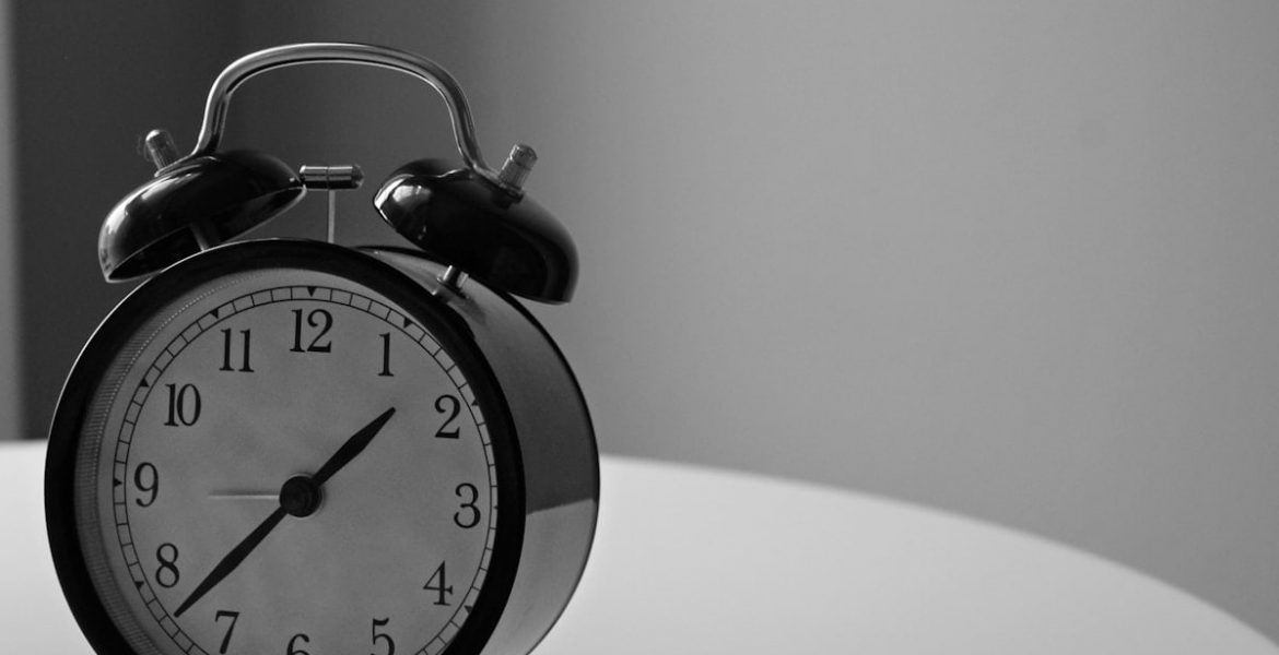 black and white photography of alarm clock displaying 1:37 time