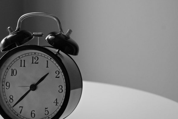 black and white photography of alarm clock displaying 1:37 time
