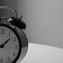 black and white photography of alarm clock displaying 1:37 time
